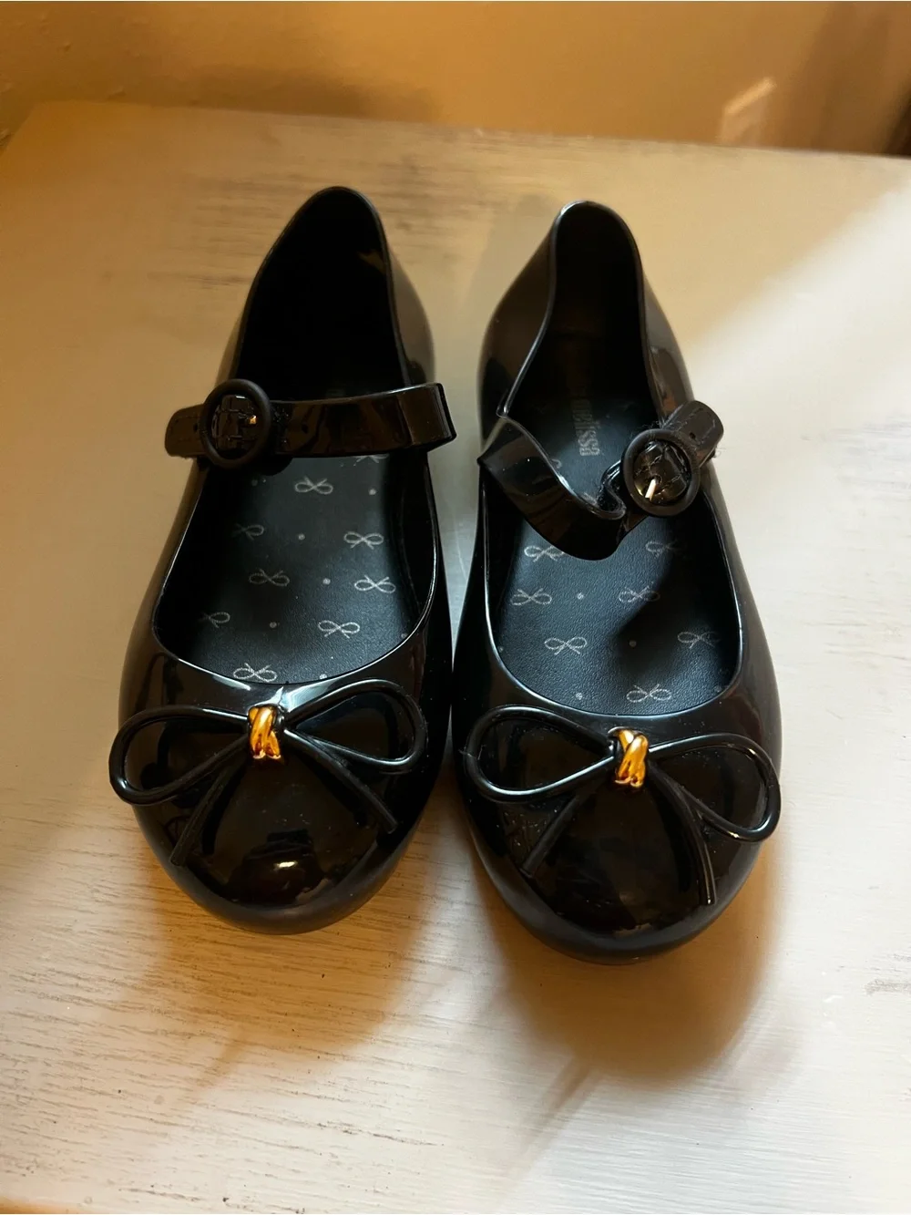 Mini Melissa Black Patent Mary Jane Flats with Gold Bow Accent
